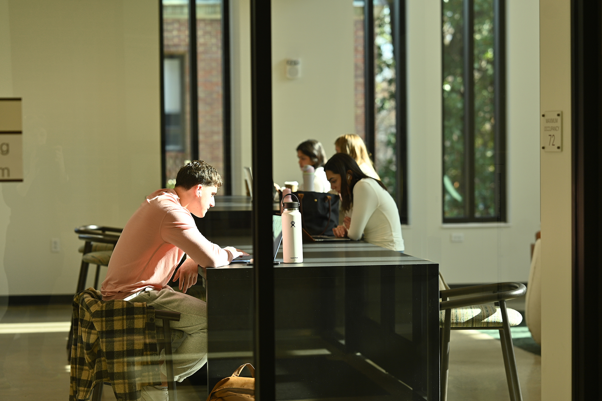 A photo of students studying at tables