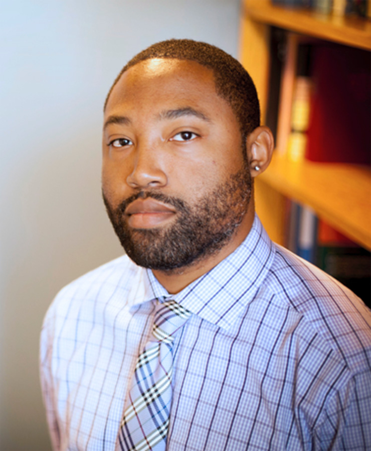 Chemistry professor Steve Townsend standing in front of a bookcase